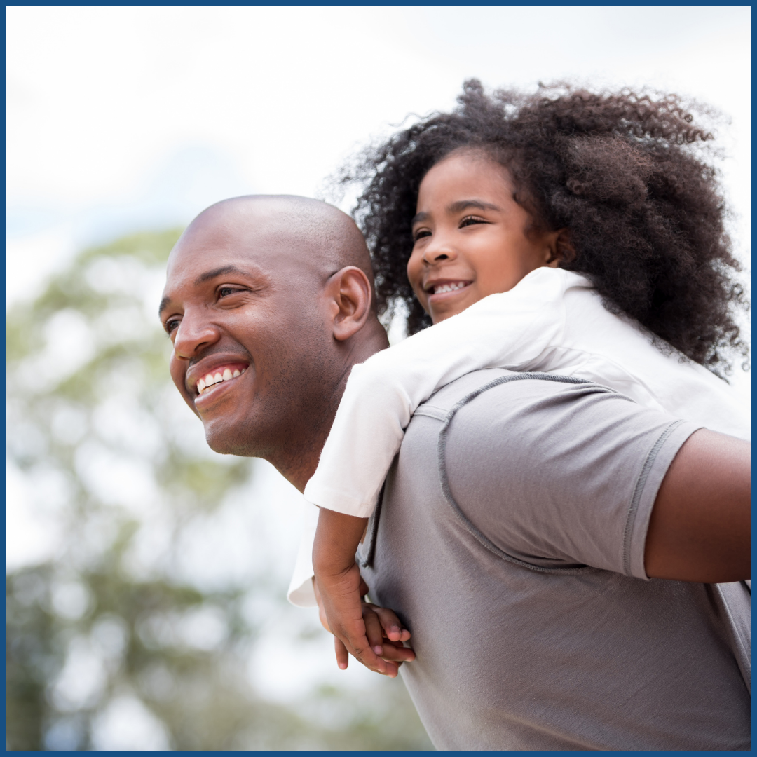 a black man and his daughter who is on his shoulders.