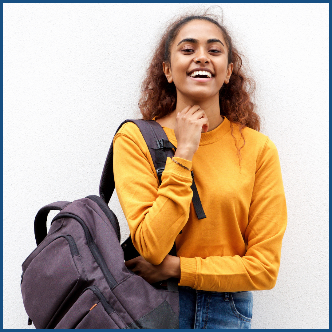 a southern asian woman smiling with a backpack